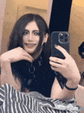 a person is taking a selfie in front of a mirror .