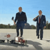 two men standing next to a truck that says impact on it