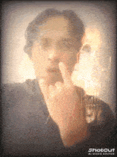 a man giving the middle finger with a shotcut ai video editor in the background