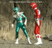 a green power ranger and a red power ranger standing next to each other .