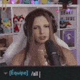 a woman wearing headphones is talking into a microphone with a sign that says shake some on it