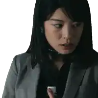 a woman in a suit has a choker around her neck and is looking at something