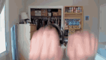 a person wearing headphones is standing in front of a closet with boxes on the shelves that say ' sally '