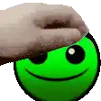 a hand is touching a green smiley face with its thumb .