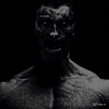 a black and white photo of a person 's face with a white light coming out of it .
