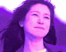 a woman with purple hair and a purple background is smiling