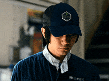a man wearing a blue hat that says " the lucky " on it