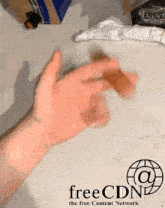 a person 's hand is holding a sausage in front of a free content network logo