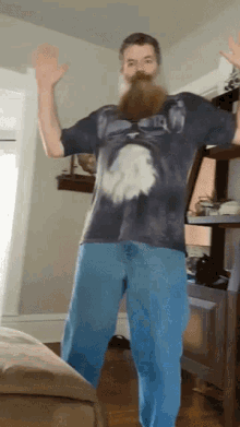 a man with a beard wearing a tie dye shirt that says eagle