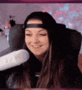 a woman is sitting in a chair with a microphone in front of her .