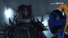 a purple monster with the word kamen rider on the bottom left