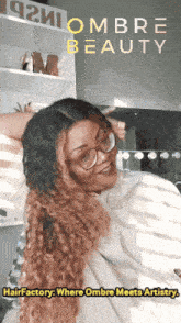 a woman wearing glasses and a white shirt with the words " hair factory where ombre meets artistry " on the bottom