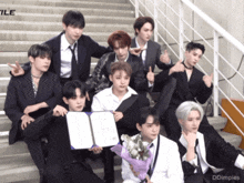 a group of young men are posing for a picture with a certificate and a bouquet of flowers