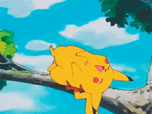 a yellow cartoon character is laying on a tree branch .
