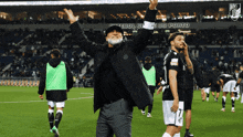 a man with a beard stands on a soccer field in front of a sign that says clube do porto