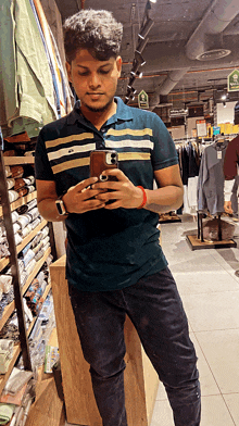 a young man taking a picture of himself in a clothing store