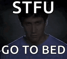 a man in a blue shirt with the words stfu go to bed above him