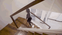 a woman is walking down a set of stairs