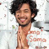 a man is smiling with confetti falling around him and the words sama sama are written in red