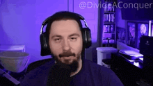 a man with a beard wearing headphones and a microphone with the words divide aconquer on the bottom right