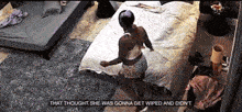 a woman is standing on a bed with the words that thought she was gonna get wiped and did n't