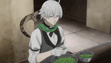 a man with a snake around his neck is preparing food
