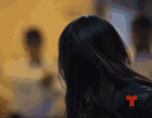 a woman 's back is shown with a red t on her back