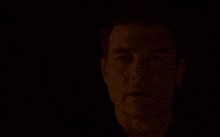 a man in the dark with the words we live and die in the shadows above him