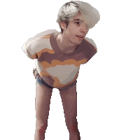 a person with short blonde hair is wearing a striped shirt and shorts