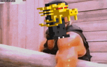 a pixelated image of a man holding a gun with the website benorgif.com in the bottom right corner