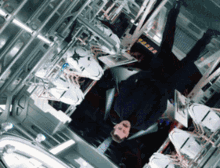 a man is laying upside down in a room with a sign that says ' star trek '