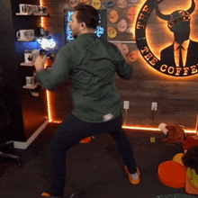a man is dancing in front of a sign for the coffee