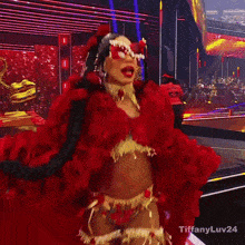 a woman in a red and gold costume is standing in front of a tiffany uv24 sign