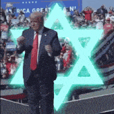 a man in a suit and tie stands in front of a sign that says " america great again "