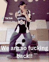 a woman is dancing with a caption that says " we are so fucking back "