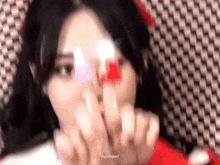 a girl in a red dress is holding a red heart in her hand .
