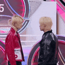 two men standing next to each other with the number 5 in the back