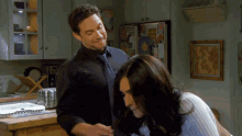 a man and a woman are standing in a kitchen
