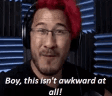 a man with red hair is wearing headphones and says boy this is n't awkward at all .