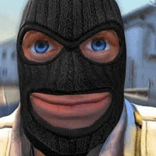 a close up of a man wearing a ski mask with blue eyes .