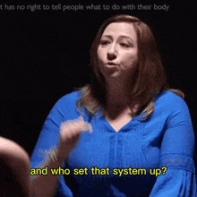 a woman in a blue shirt is asking and who set that system up