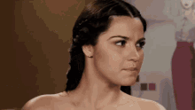 a close up of a woman 's face with a braid