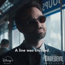 a man wearing sunglasses says a line was crossed on a daredevil poster