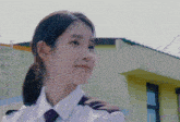 a woman in a police uniform is smiling and looking at the camera