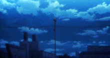 a blue sky with white clouds and a fence in the foreground .