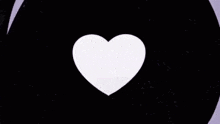 a black heart is floating in the air on a purple background