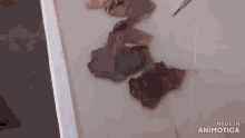 a person is painting a woman 's face and the words made in animatica are visible