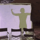 a shadow of a man is projected on a white screen