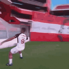 a soccer player wearing a number 9 jersey is kicking the ball