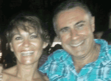 a man and a woman are smiling for a photo